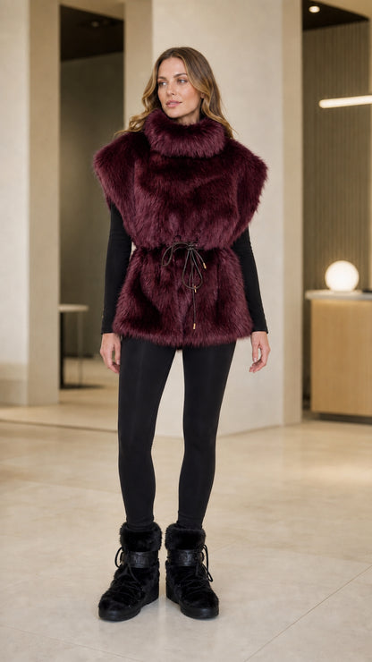 Front view of model wearing burgundy wine high-neck plush faux fur vest with drawstring waist
