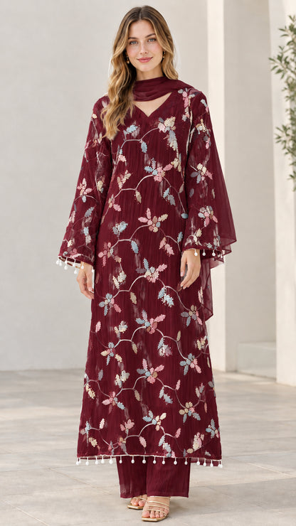 Model wearing deep burgundy embroidered 3-piece kurta set