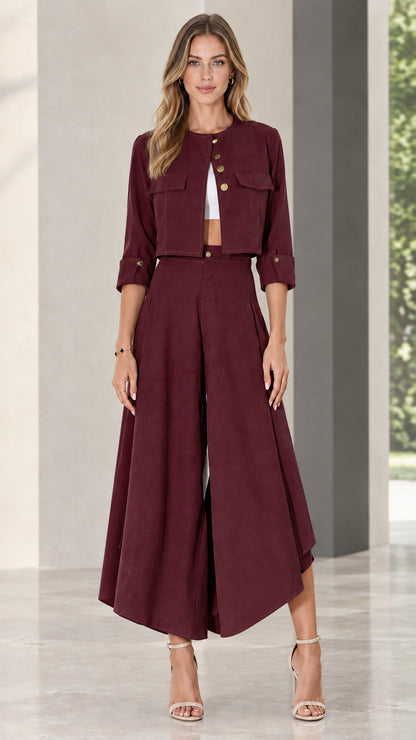 Model wearing burgundy red cropped jacket and flowing pant set