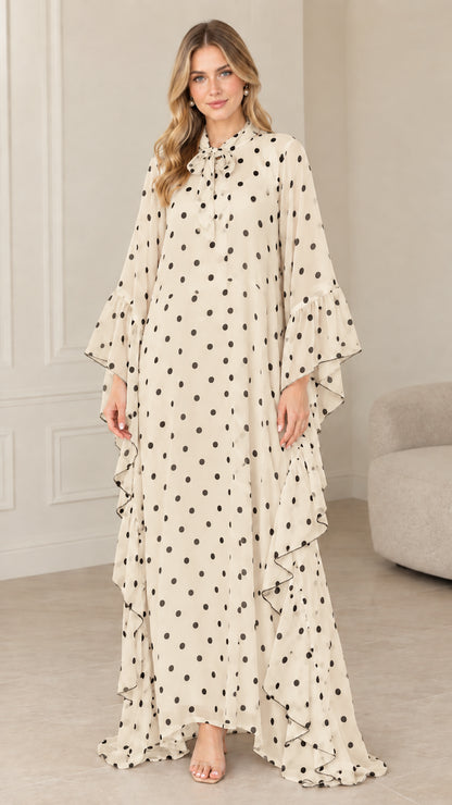 Full front view of beige cream polka dot tie neck kaftan maxi dress