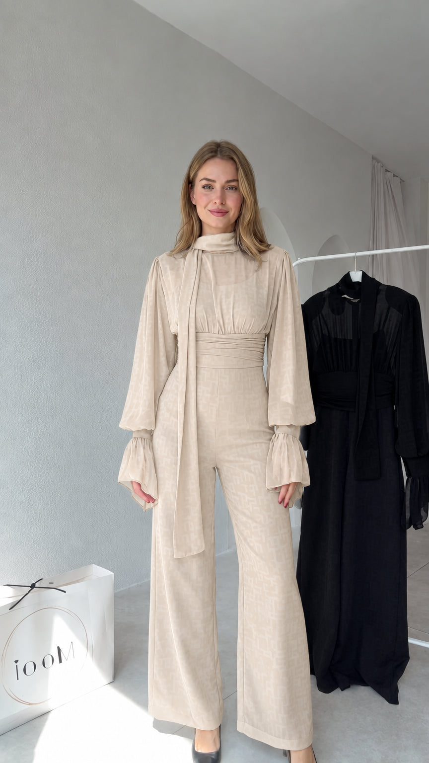 Full front view of model wearing Beige tie-neck wide-leg jumpsuit