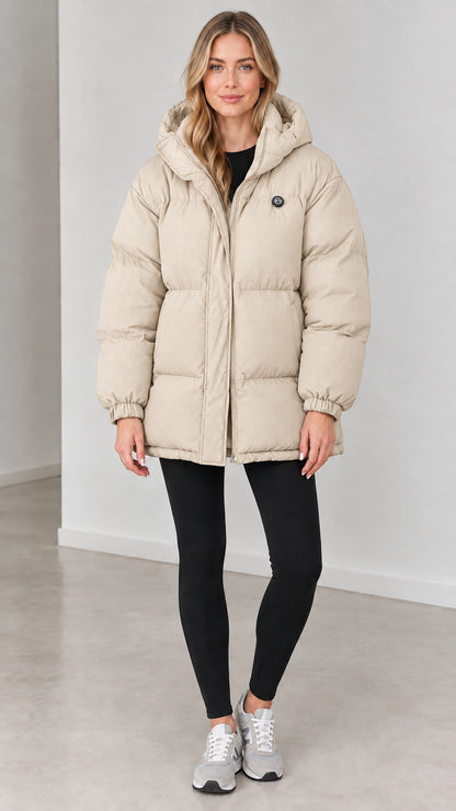 Front view of woman wearing cream beige hooded quilted puffer jacket