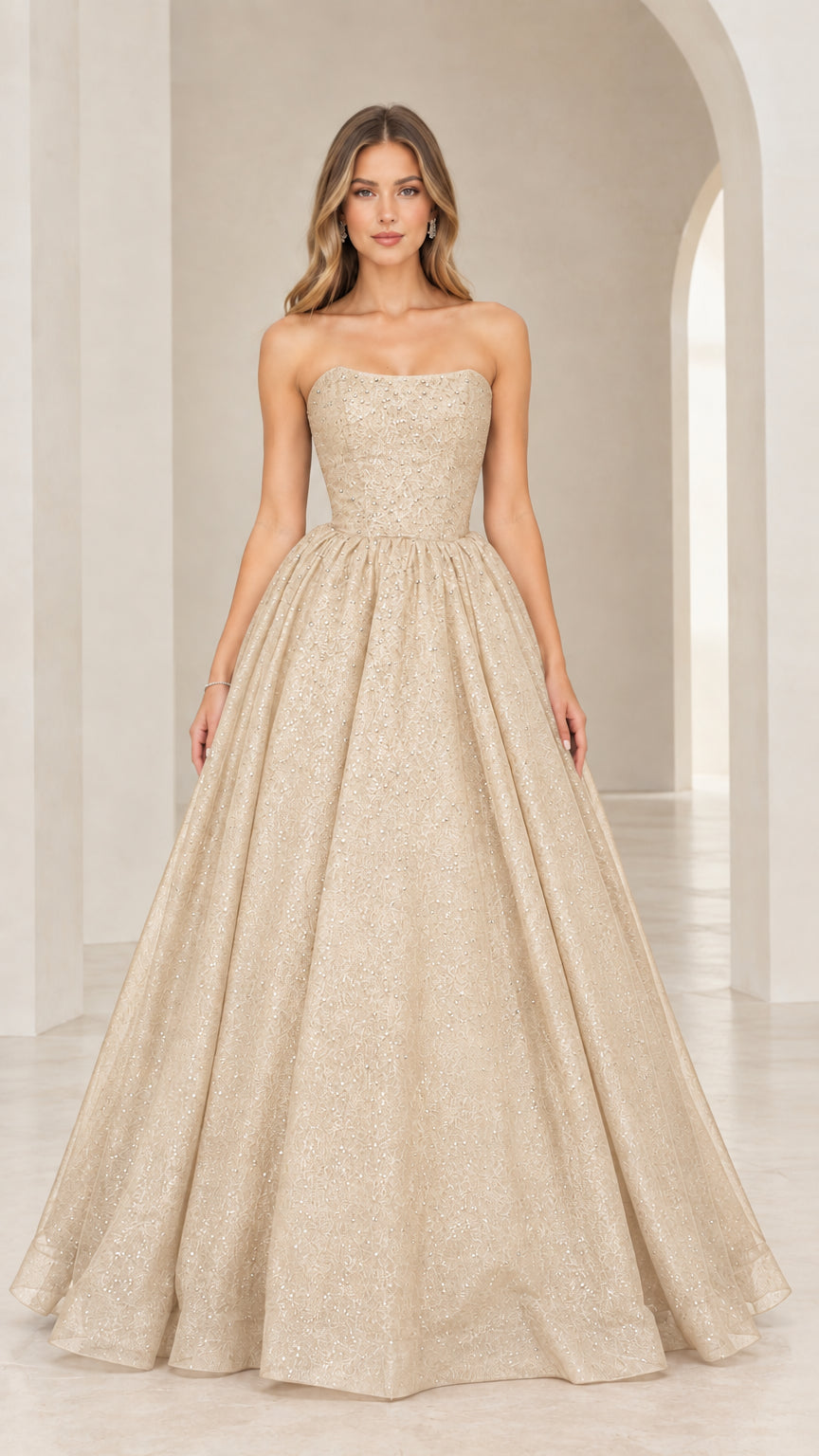 Front view of model in champagne gold strapless shimmering evening gown