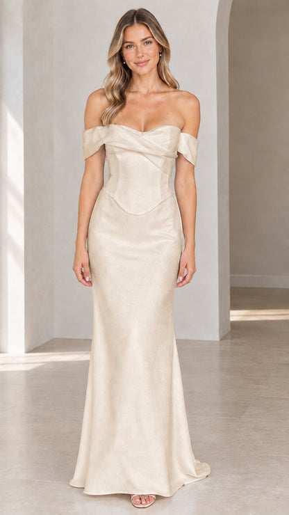 Woman wearing champagne beige off-the-shoulder corset maxi evening dress