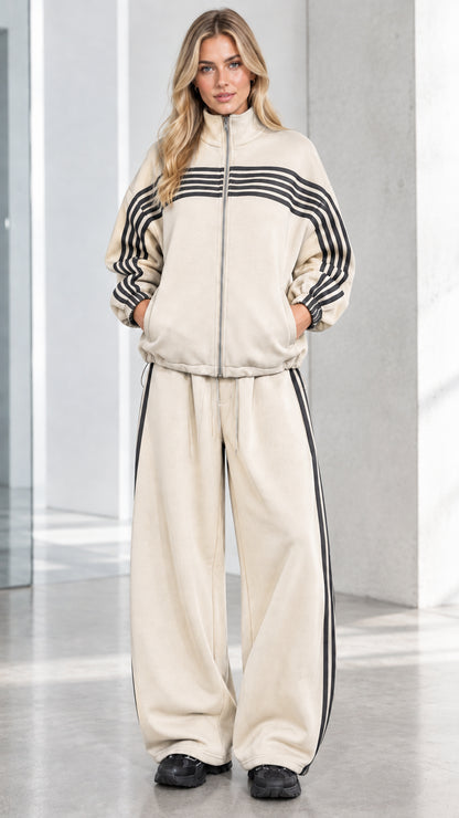 Front full view of woman wearing Beige cream striped zip-up track jacket and wide-leg sweatpants set