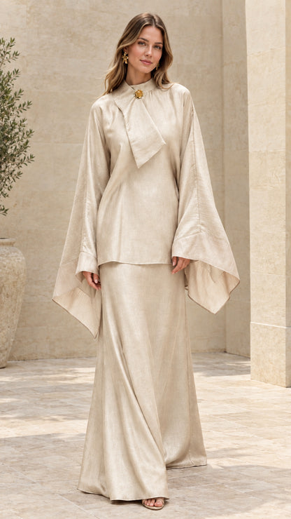 Model wearing champagne cream draped tunic top and maxi skirt set