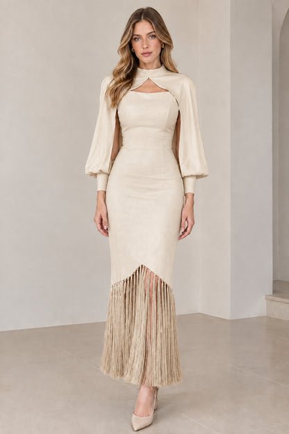 Model wearing champagne beige high neck cape sleeve midi dress with matching fringe