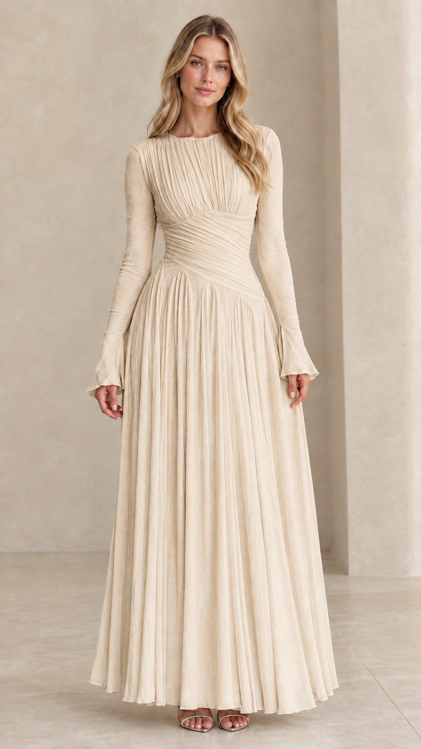 Model wearing champagne beige long sleeve pleated evening gown
