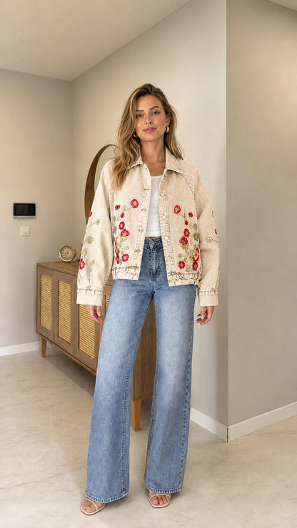 Full front view of woman wearing Cream off-white floral embroidered denim jacket