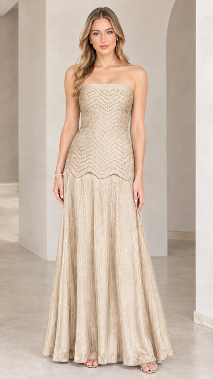 Full-length view of model in champagne gold strapless beaded evening gown