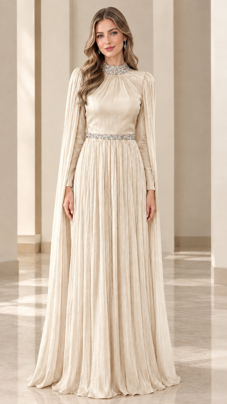 Front view of champagne cream pleated maxi gown with crystal embellishments