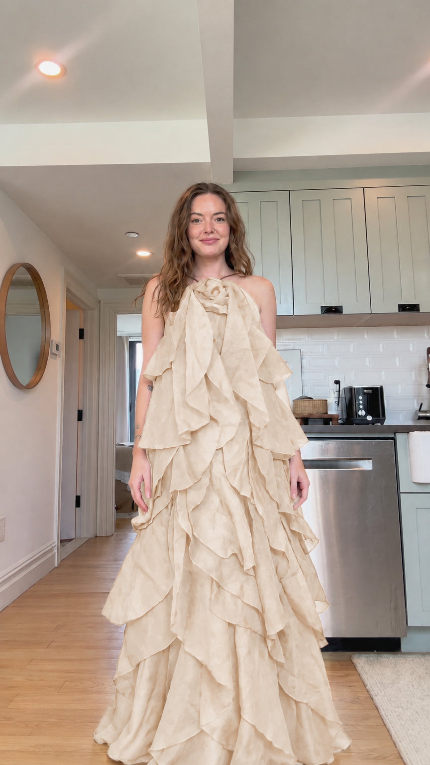 Front view of model wearing champagne beige tiered ruffle rosette maxi dress