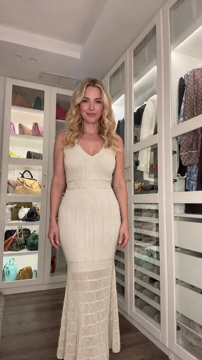 Front view of woman wearing cream sleeveless embellished knit maxi dress