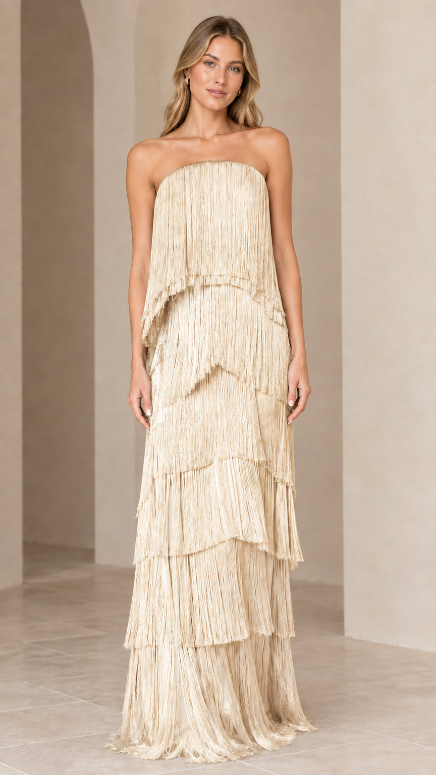 Full-length view of strapless tiered fringe maxi dress in champagne