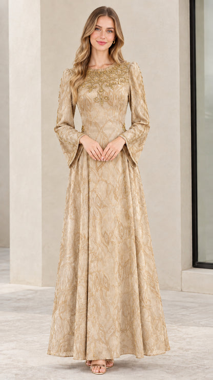 Model wearing champagne gold long-sleeve beaded jacquard gown
