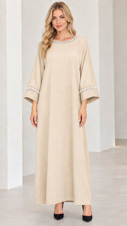 Front view of woman wearing beige champagne pearl trim modest maxi dress