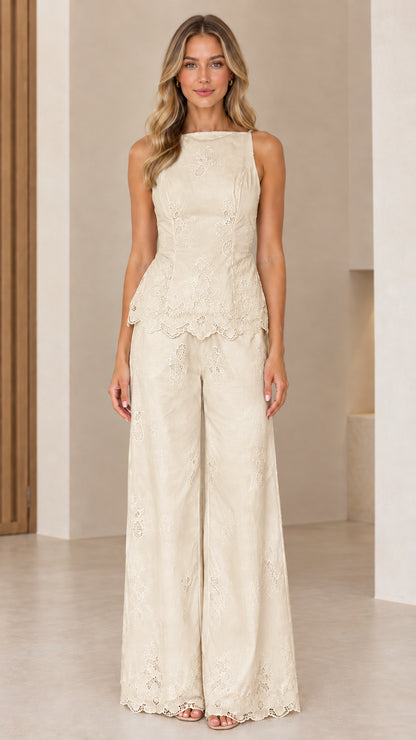 Full length view of model wearing champagne beige embroidered peplum pant set