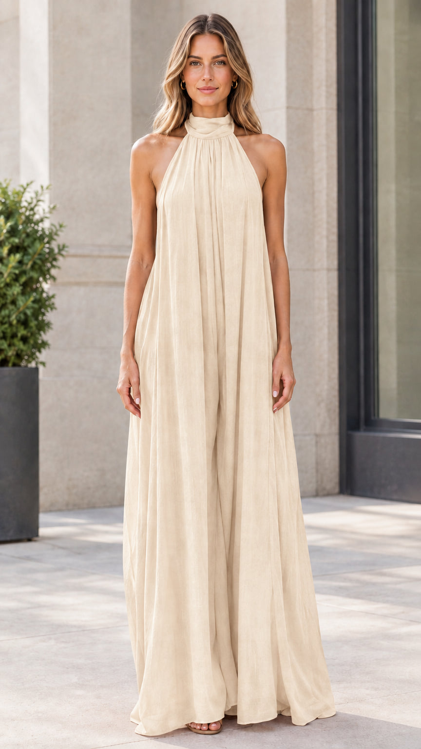 Front view of model wearing cream beige halter neck wide-leg jumpsuit