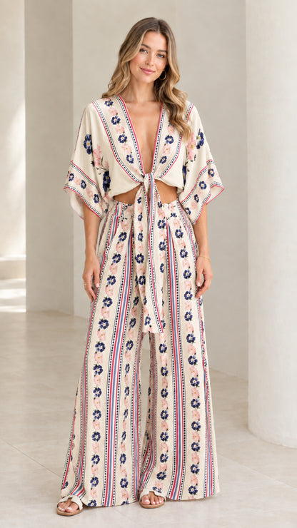 Model wearing cream beige floral stripe tie-front top and wide-leg pants two-piece set
